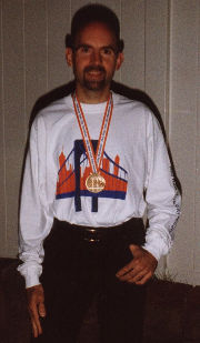 Ray proudly displays his medal and t-shirt